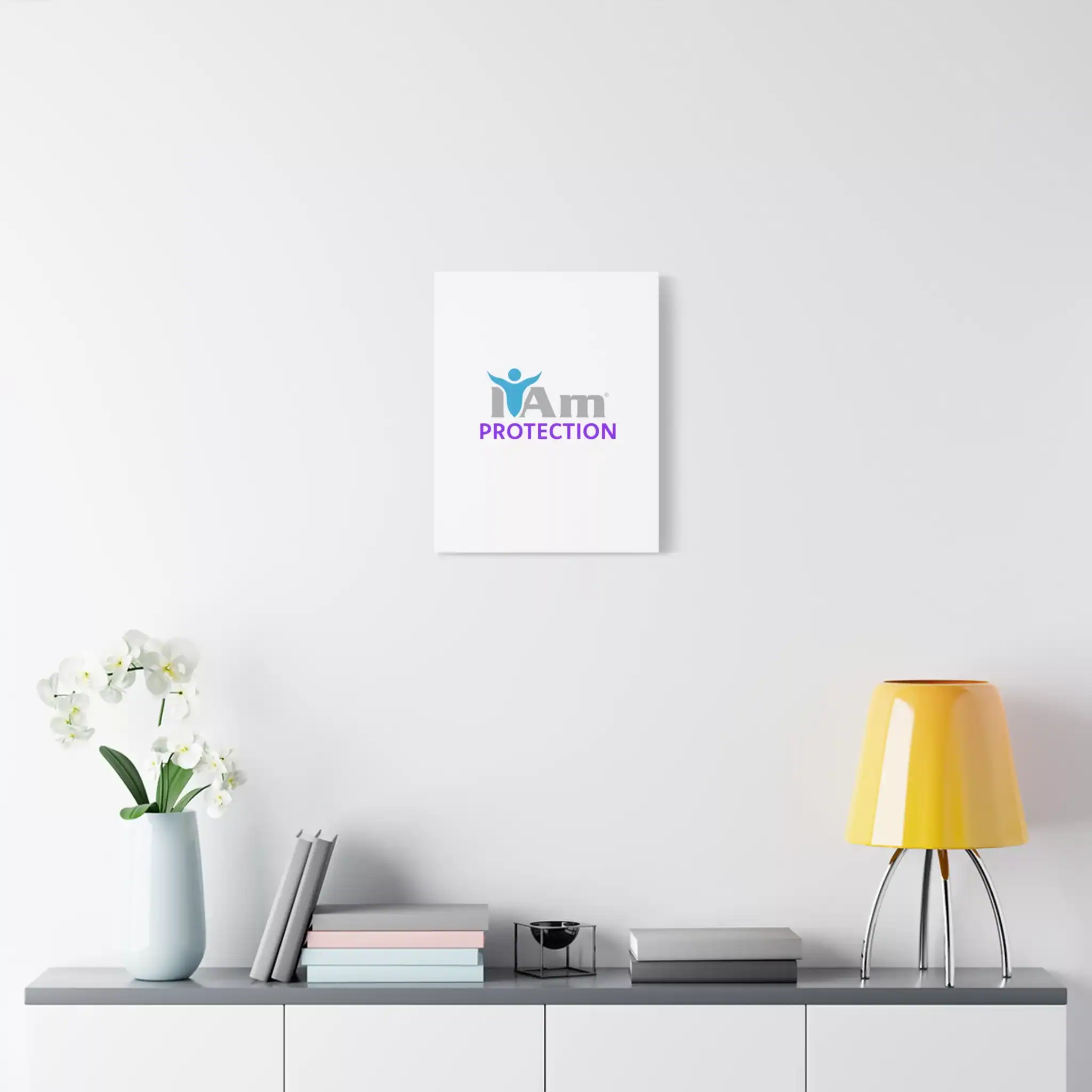 14357269458392852021_2048.webp Minimalist wall art with 'I Am Protection' text and logo on a white wall.