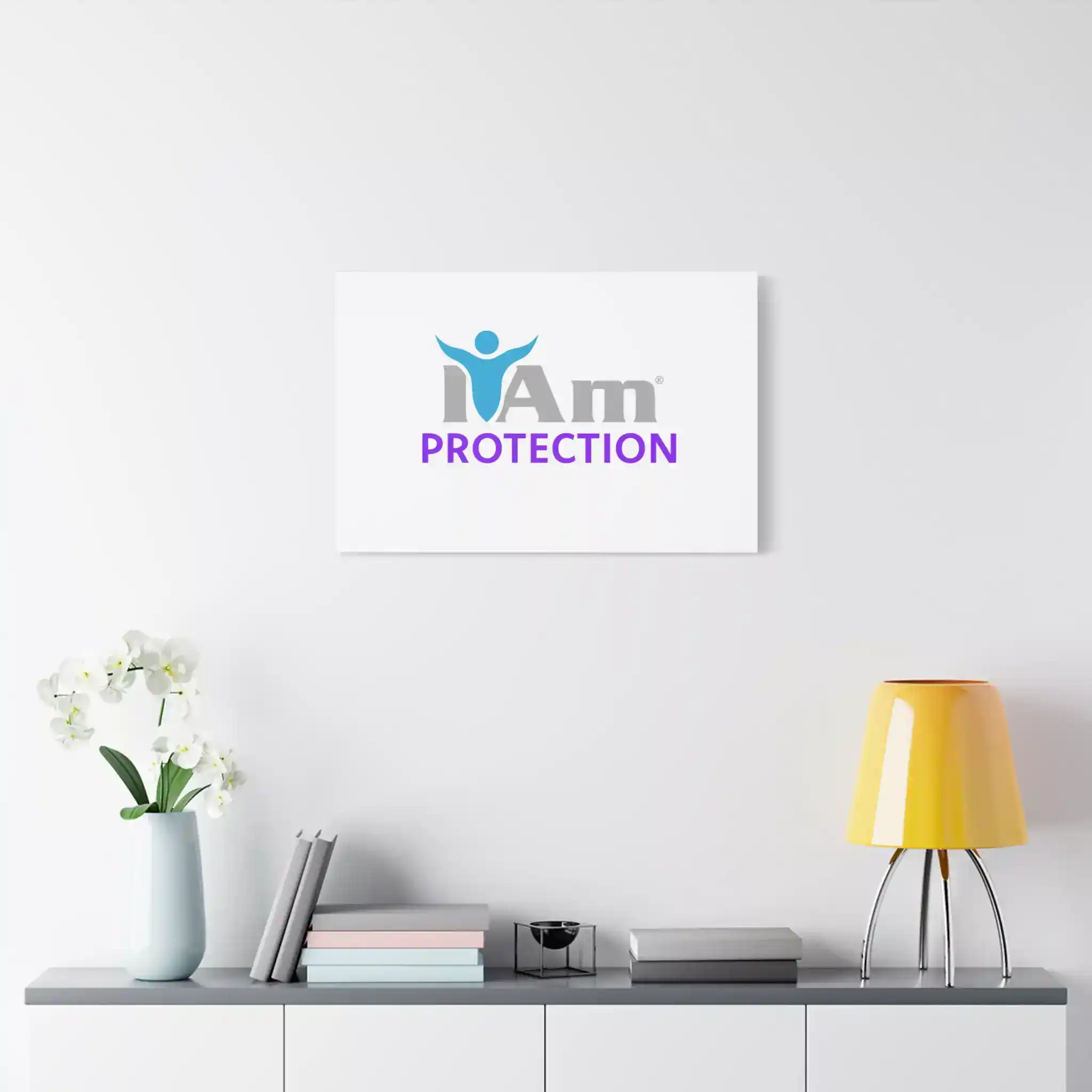 5519185334066658178_2048.webp I Am Protection logo on a white wall with a yellow lamp and books.