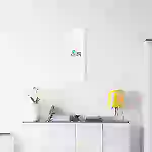 Minimalist white wall with a motivational canvas art and decor items.