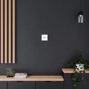 Minimalist interior with a small wall art piece on a dark wall.