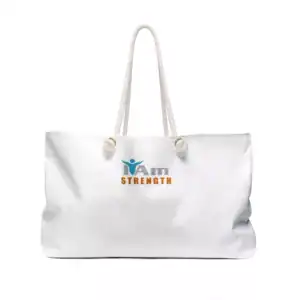 White canvas travel tote bag with 'I Am Strength' logo and handles for travel and gym use.