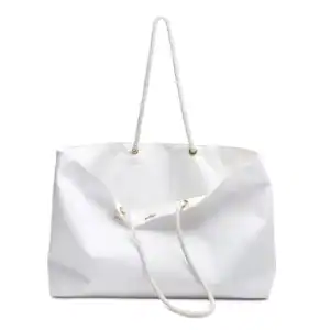 White canvas tote bag with rope handles for travel and everyday use.